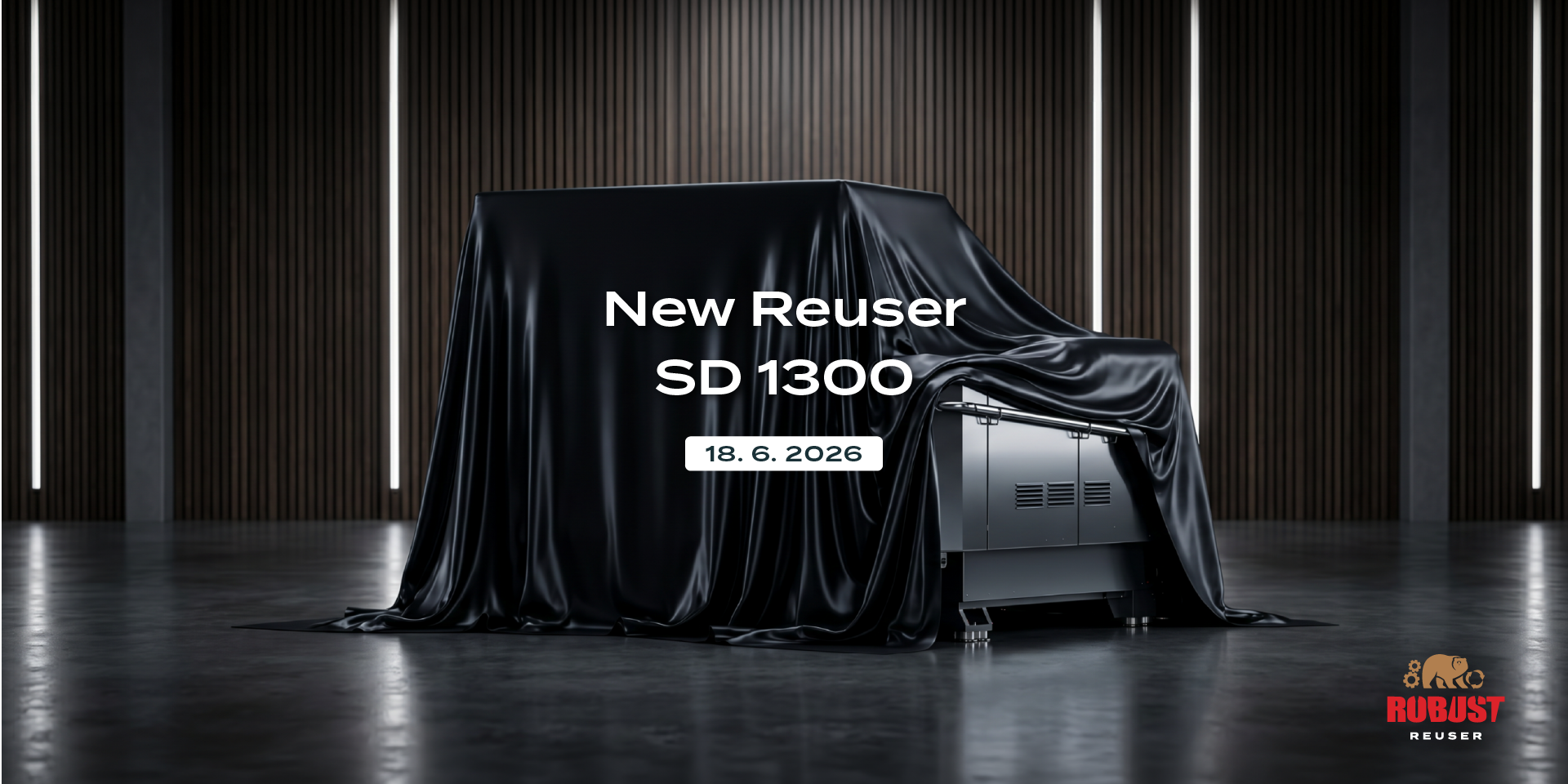 Industrial shredder Robust Reuser SD 1300 dramatically covered with a black cloth in a modern showroom. Image includes the Robust Reuser logo and text: Prihaja Reuser SD 1300, 18. 6. 2026.